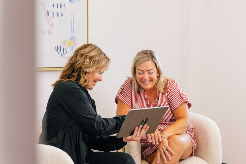 Woman meeting with a provider for a wellness consultation to discuss fatigue, weight gain, hormone changes, and personalized support during perimenopause.