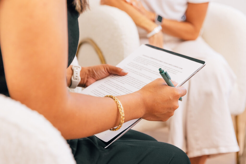 A patient at The Pip Rx reviews a medical intake form before beginning their BHRT near Leawood. A patient's medical history plays an important role in tailoring a BHRT treatment plan. 