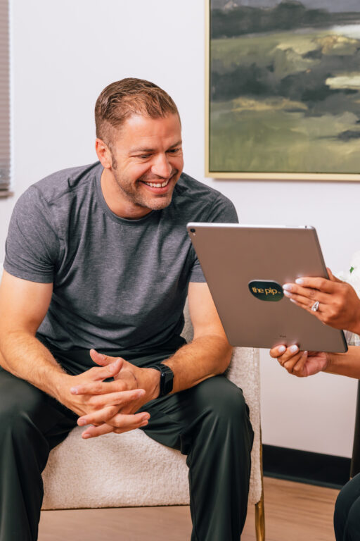 Male client meeting with a provider during a personalized peptide therapy consultation at The Pip Rx in Overland Park to discuss wellness goals and treatment options.